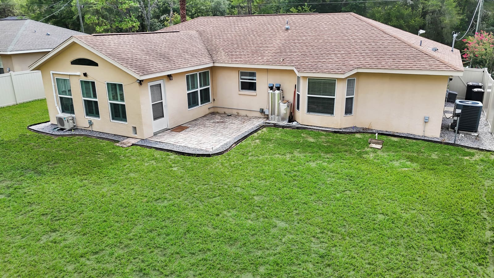 Backyard with covered porch and vinyl fence