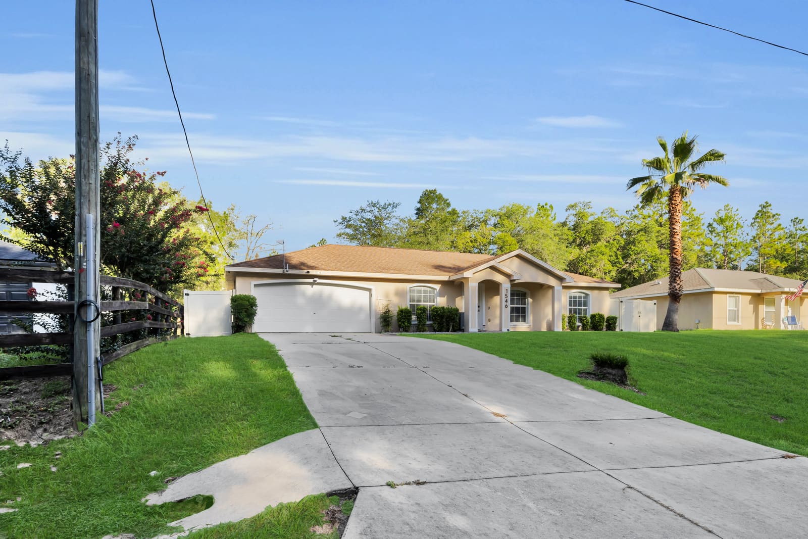 Long concrete driveway leading to the house and garage