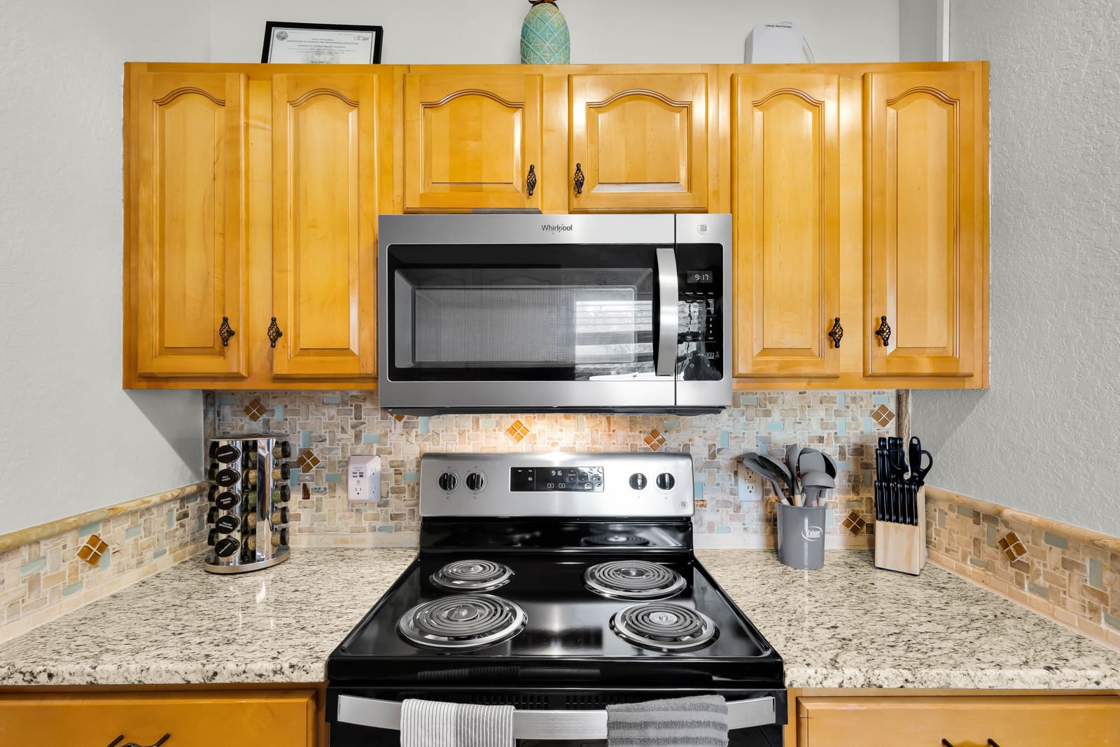 Kitchen with stainless range, granite counters, and wood cabinets