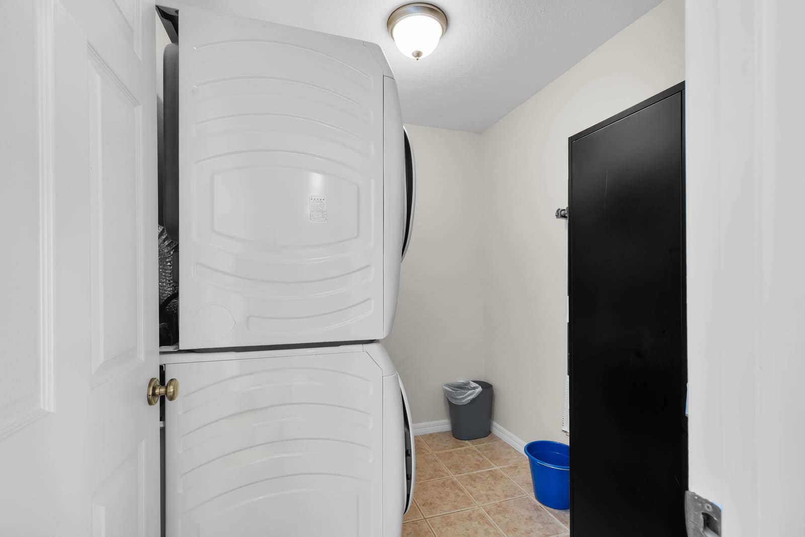 Laundry area with two stacked washer and dryer sets