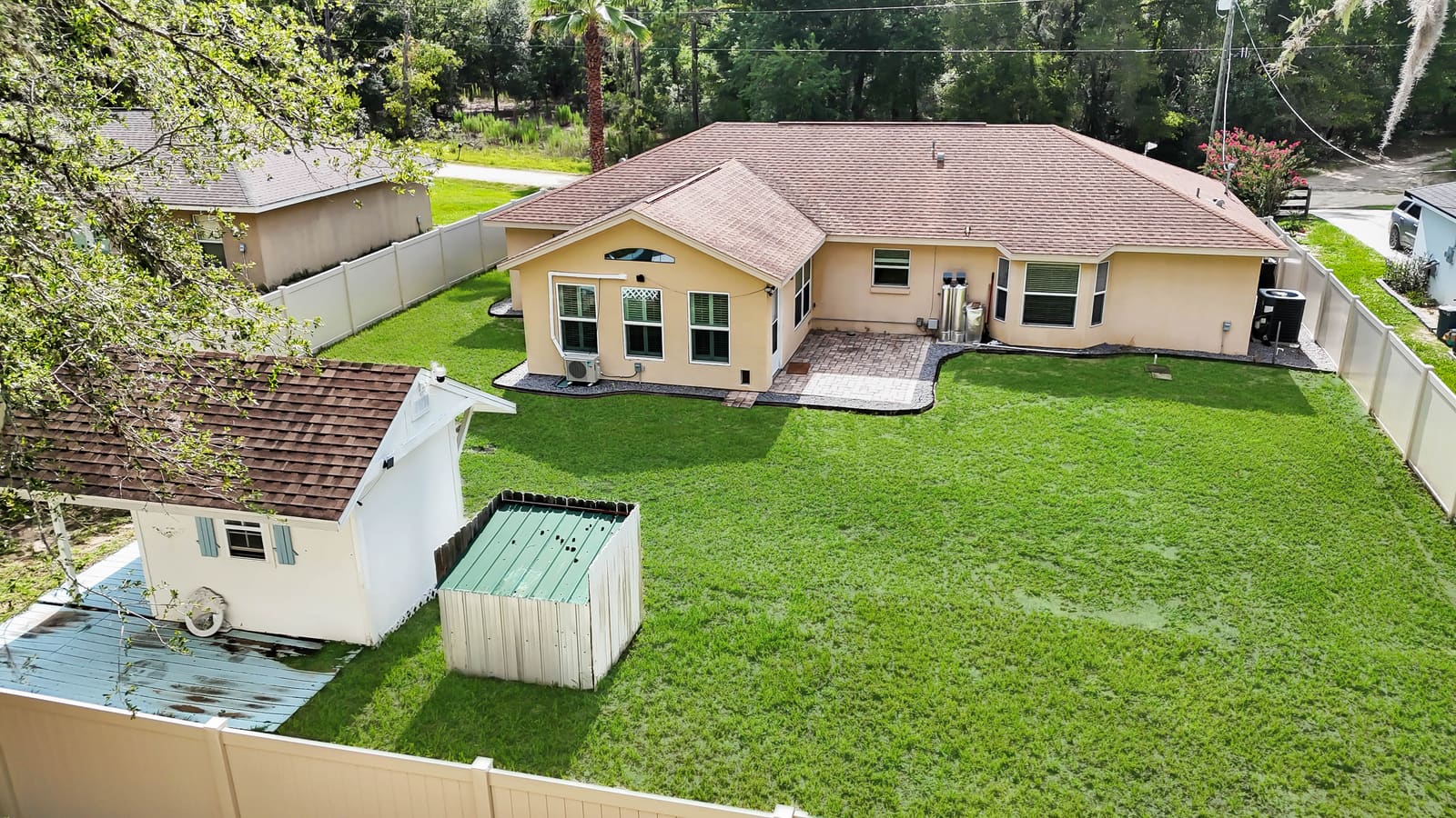 Aerial view of the house and fully fenced backyard